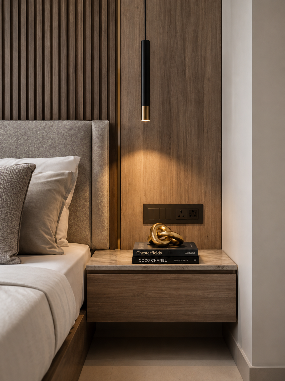 Completed joinery detail — fluted timber panelling, marble-topped bedside unit and pendant light