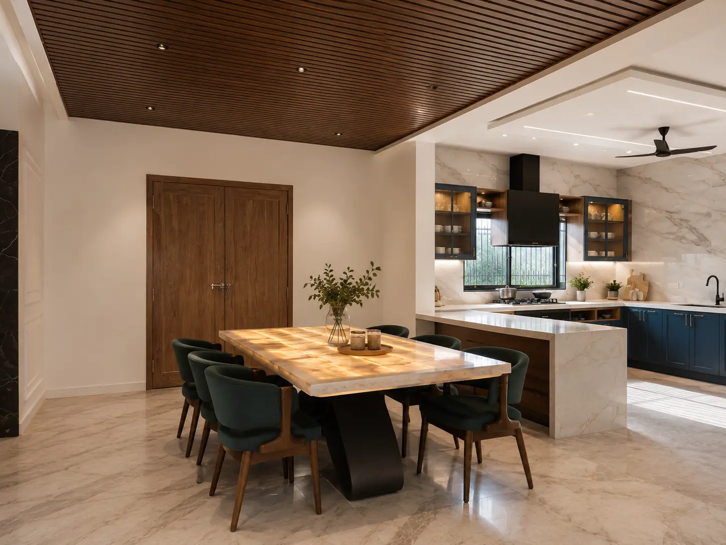 Dining table in stone and timber alongside the open kitchen with navy cabinetry and a marble backsplash